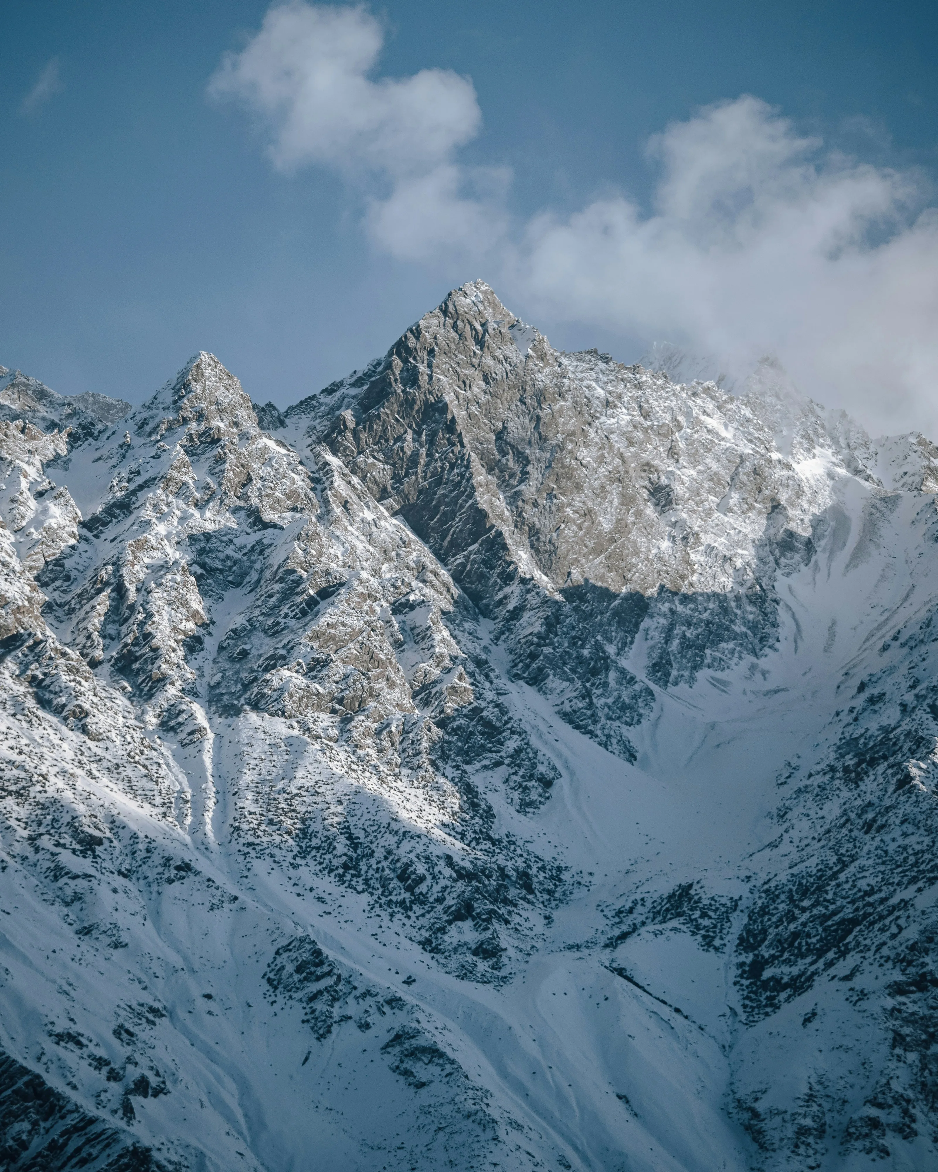 Snow-plastered granite summit above a broad glacier basin, Karakoram
